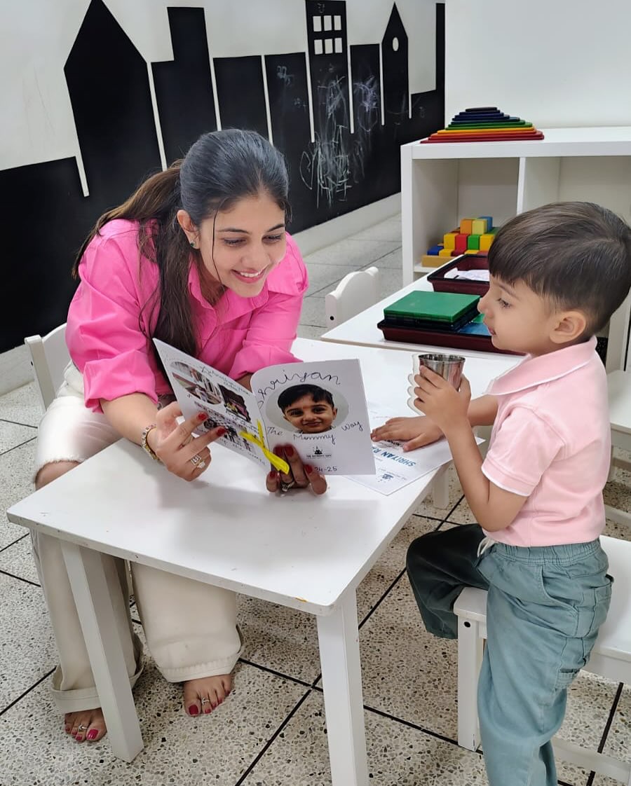 A teacher and a little one reading together at The Mommy Way